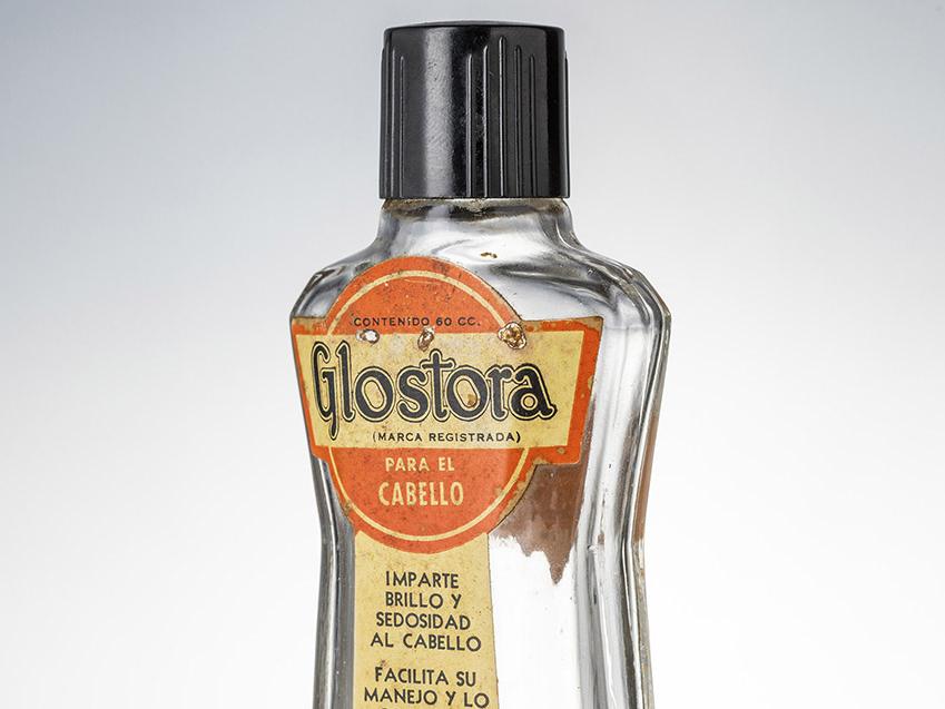 Botella de brillantina y fijador capilar Glostora